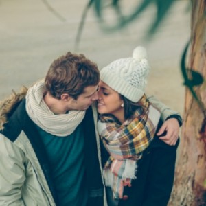 Young couple in love embracing and kissing outdoors