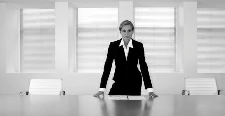 Businesswoman Standing At Conference Table